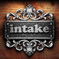 intake word of iron on wooden background photo