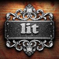 lit word of iron on wooden background photo