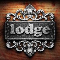 lodge word of iron on wooden background photo