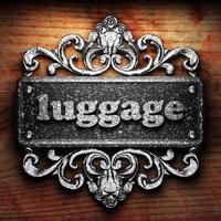 luggage word of iron on wooden background photo