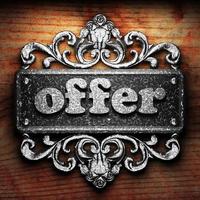 offer word of iron on wooden background photo