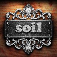 soil word of iron on wooden background photo