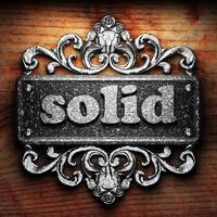 solid word of iron on wooden background photo