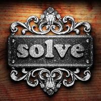 solve word of iron on wooden background photo