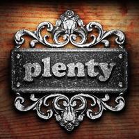 plenty word of iron on wooden background photo