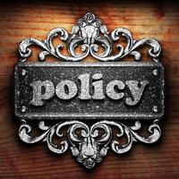 policy word of iron on wooden background photo