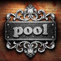 pool word of iron on wooden background photo