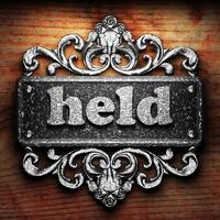 held word of iron on wooden background photo