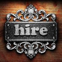 hire word of iron on wooden background photo