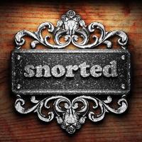 snorted word of iron on wooden background photo