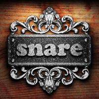 snare word of iron on wooden background photo