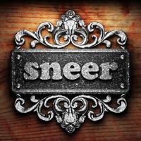 sneer word of iron on wooden background photo