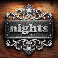 nights word of iron on wooden background photo