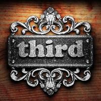 third word of iron on wooden background photo