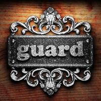 guard word of iron on wooden background photo