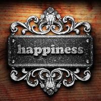 happiness word of iron on wooden background photo