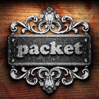 packet word of iron on wooden background photo