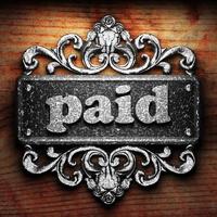 paid word of iron on wooden background photo