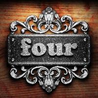 four word of iron on wooden background photo