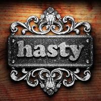 hasty word of iron on wooden background photo