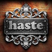 haste word of iron on wooden background photo