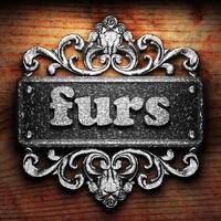 furs word of iron on wooden background photo