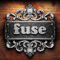 fuse word of iron on wooden background photo