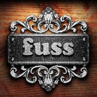 fuss word of iron on wooden background photo