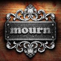 mourn word of iron on wooden background photo