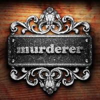 murderer word of iron on wooden background photo