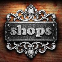 shops word of iron on wooden background photo