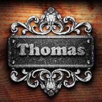 Thomas word of iron on wooden background photo