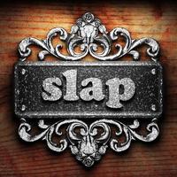 slap word of iron on wooden background photo