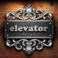 elevator word of iron on wooden background photo