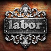 labor word of iron on wooden background photo