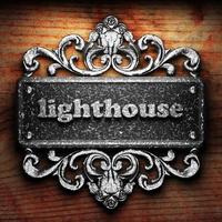 lighthouse word of iron on wooden background photo