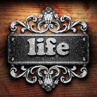 life word of iron on wooden background photo