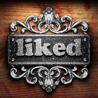 liked word of iron on wooden background photo