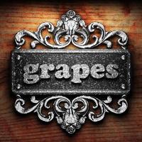 grapes word of iron on wooden background photo