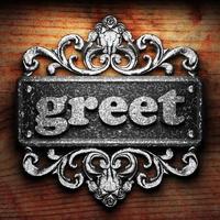 greet word of iron on wooden background photo