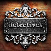 detectives word of iron on wooden background photo