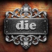 die word of iron on wooden background photo