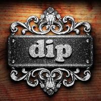 dip word of iron on wooden background photo