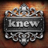 knew word of iron on wooden background photo