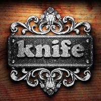 knife word of iron on wooden background photo