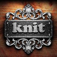 knit word of iron on wooden background photo