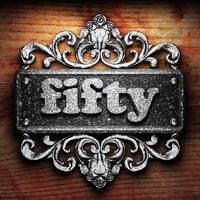 fifty word of iron on wooden background photo