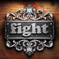 fight word of iron on wooden background photo