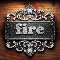 fire word of iron on wooden background photo