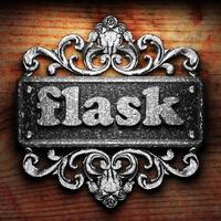 flask word of iron on wooden background photo